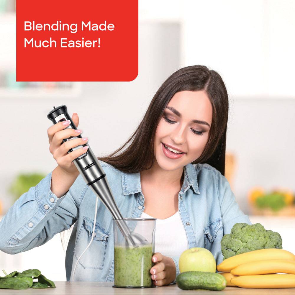 Handheld stick blender with blending shaft and control buttons in use