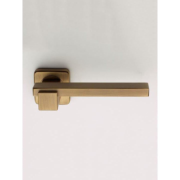 Brass lever door handle with square rose backing plate, brushed brass finish