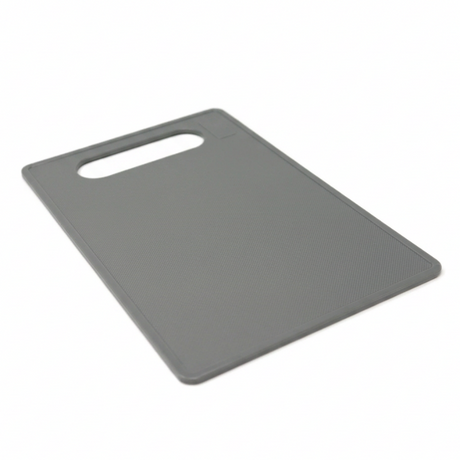 Grey plastic cutting board with handle slot and textured surface