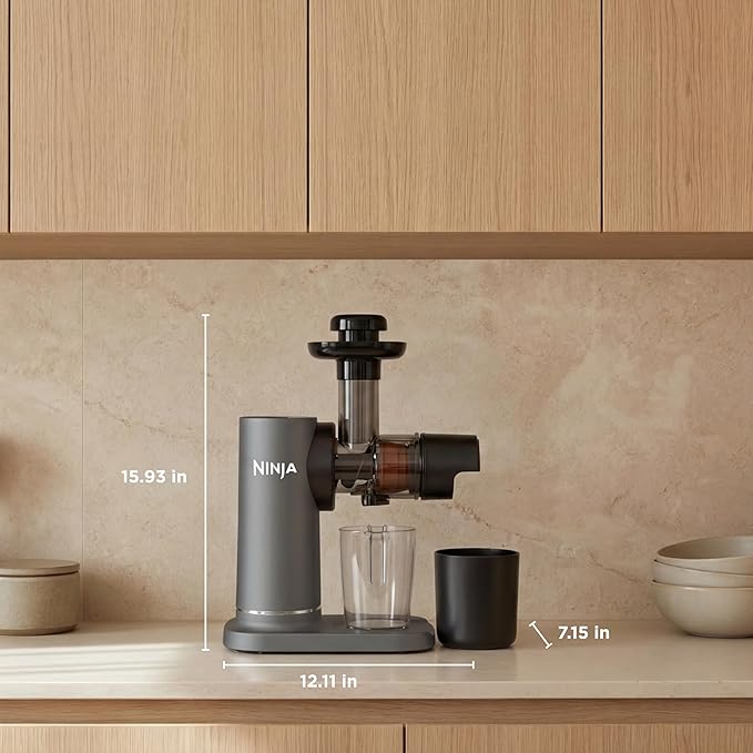 Cold press juicer with measurement layout, showing dimensions and components on the countertop