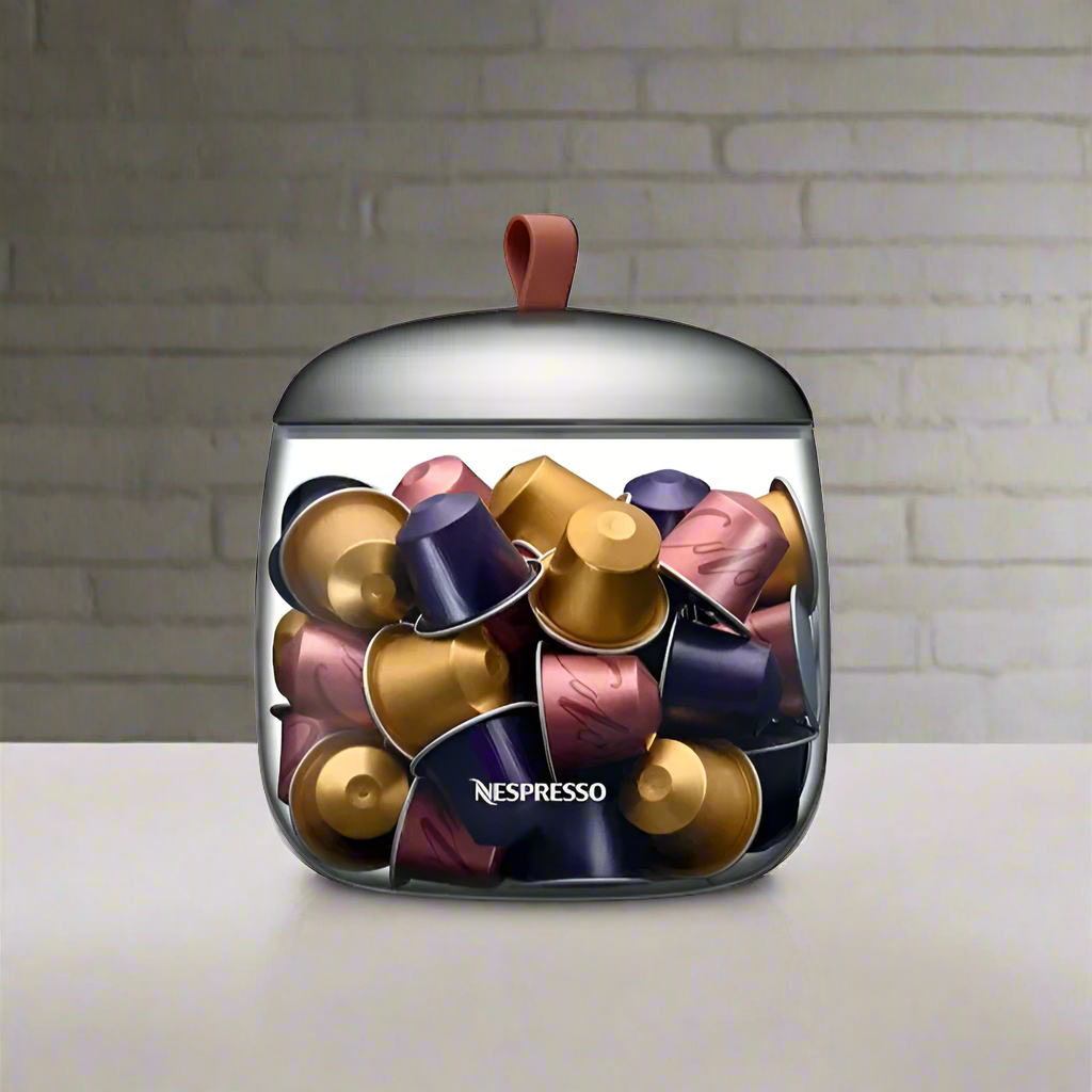 Nespresso capsule dispenser with clear front and domed stainless lid, holding mixed capsules.
