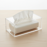Clear acrylic tissue box with a tissue roll standing on the open top