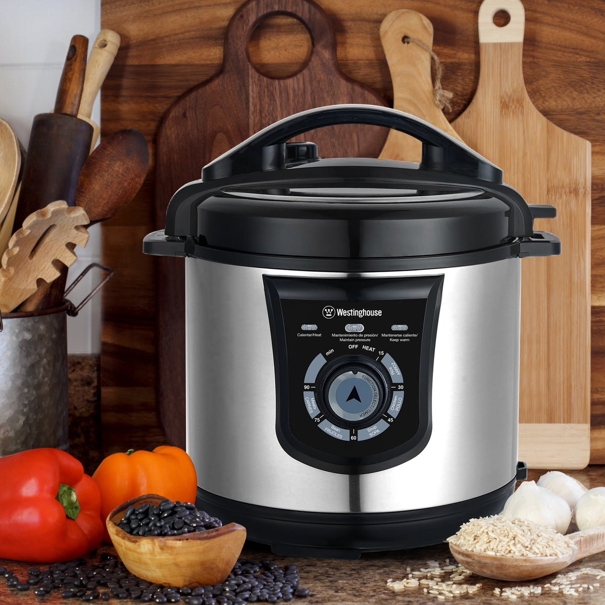 Stainless steel electric pressure cooker with black control panel and steam lid
