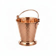 A hammered copper ice bucket with a polished stainless steel interior and a copper-colored metal handle, shown on a plain white background.